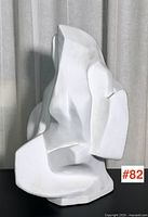Front view showing full form of white abstract sculpture