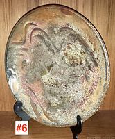 Front view of glazed charger on stand