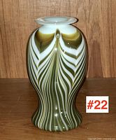 Front view of signed Canadian studio art glass vase showing pull-feather pattern