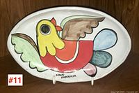 Full view of oval platter with bird motif and signature