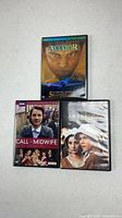 Front covers of three DVD cases: The Aviator, Call of the Midwife S2, The Awakening Land