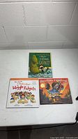 All three hardcover children's books on tabletop