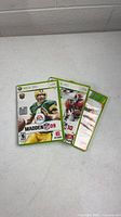 Front view of three Xbox 360 Madden NFL game cases