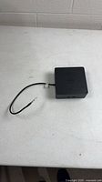 Overall view of Dell K16A dock with attached cable