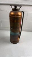 Full view of copper fire extinguisher with hose attached