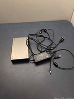Hard drive with power brick, AC cord and USB cable on tabletop
