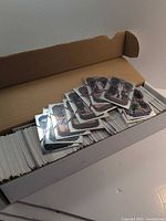 Open 800-count box filled with trading cards, small stack of assorted cards displayed on top