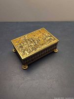 Top view showing embossed historical scene on lid