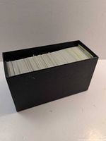 black storage box filled with Pokémon cards