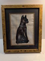 Front view of framed Egyptian papyrus cat painting