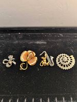 All four brooches together