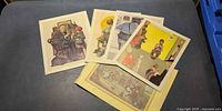 Group of six Rockwell prints spread on table