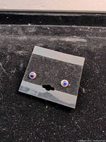 Front view of earrings on card showing stone color and bezel setting