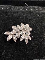 Front view of silver-tone floral rhinestone brooch