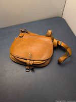 Top view of tan leather satchel closed
