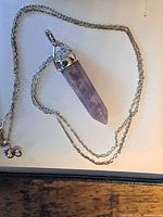Amethyst pendant and sterling chain laid flat