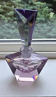 Full view of faceted amethyst cut crystal perfume bottle and stopper