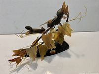 Full view of Chinese hardstone sculpture showing squirrels, grape leaves, clusters, wire tendrils, and wood stand with origin label