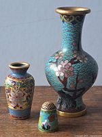 Front view of three cloisonne miniatures