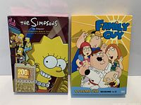Front view of both DVD box sets showing titles and cover art