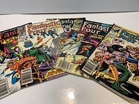 All five Fantastic Four comic books fanned out, showing each cover