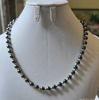 Full view of the hematite beaded necklace displayed on bust
