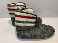 Side view of slipper boots showing knit pattern and tags