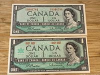 Front view of both $1 banknotes, 1954 and 1967 issues, showing portraits, serials, signatures, centennial logo and overall condition