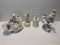 Group shot of four ceramic figurines