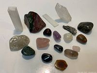 Overall view of approximately seventeen stones including selenite, quartz, bloodstone and assorted tumbles