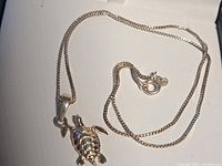 Necklace laid out showing pendant detail and clasp