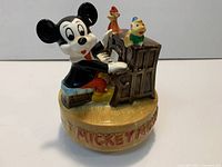 Front view showing Mickey Mouse at piano, birds and base detail
