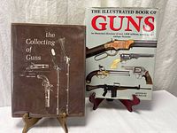 Front view of both hardcover firearm reference books on stands