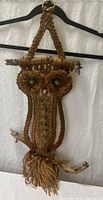 Full view of macramé owl hanging from ring