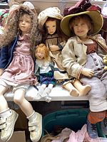 Group shot of four dolls on bench