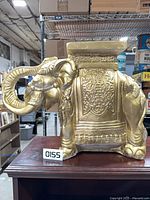 Full view of gold chalkware elephant plant stand