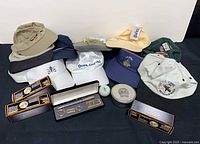 Group shot of all items: caps, ball boxes, gift set, tin, loose ball