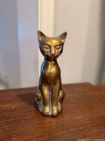Front view of brass cat sculpture