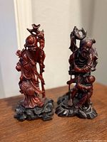 Front view of both carved Shou Lao statues on bases