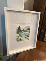 Front view of framed watercolor landscape painting