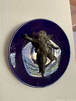 Front view of cobalt blue plate with metal cherub