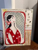 Front view of painting showing stylized female figure in red dress