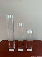 Front view of three graduating height crystal candlesticks