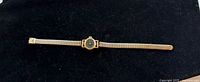 Full view of Seiko gold-tone wristwatch laid flat