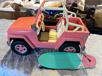 Side view of Jeep and surfboard