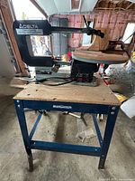 Delta scroll saw on blue stand, full view