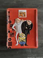 Closed red tin showing Despicable Me 3 characters