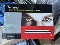 Front of retail box showing iView 6000KR karaoke player and remote