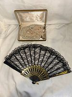 Pearl jewelry in open case with folded lace fan