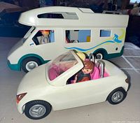 Camper, convertible and figures visible